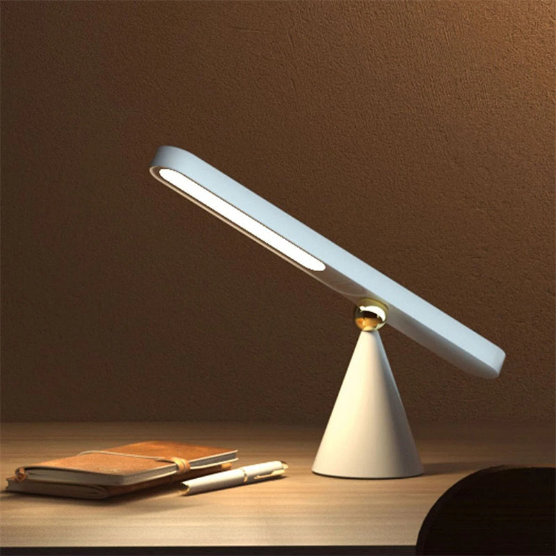 Modern desk lamp on a wooden surface with a brown background