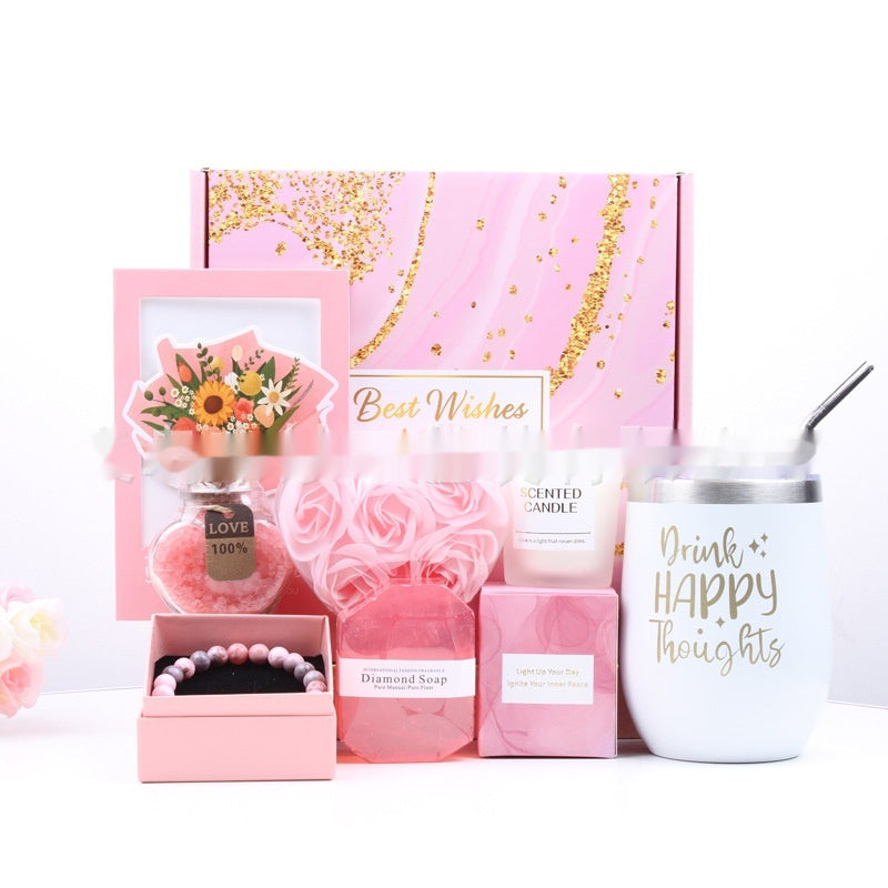 Collection of pink-themed products including a candle, soap, and tumbler with 'Drink Happy Thoughts' text.