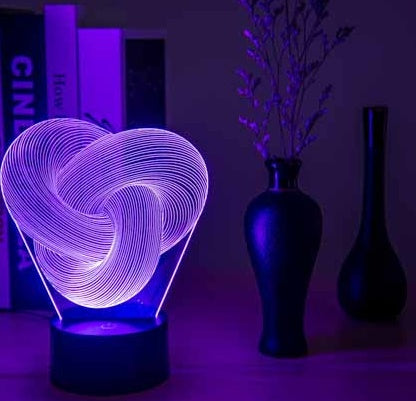 3D heart-shaped light on a table with dark background