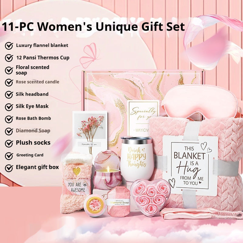 11-piece women's gift set with pink blanket, thermos cup, and various items on a pink background.