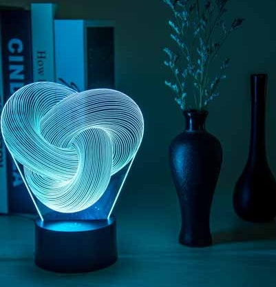 3D heart-shaped light on a table with dark background