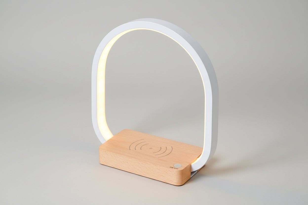 Modern table lamp with wooden base and white arch on a white background