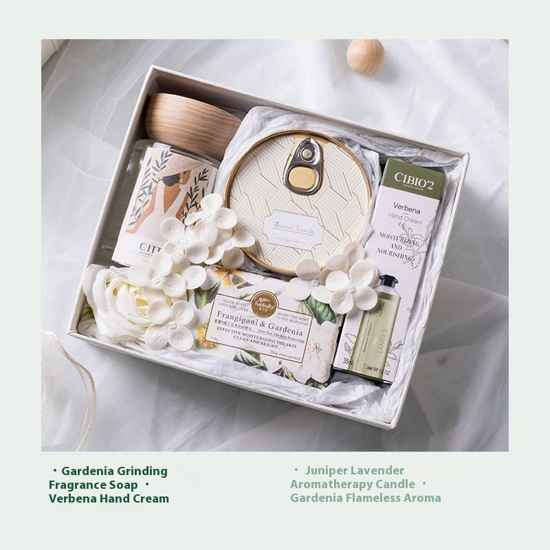 Gift set with CIBIO2 products including soap, candle, and hand cream on a light background