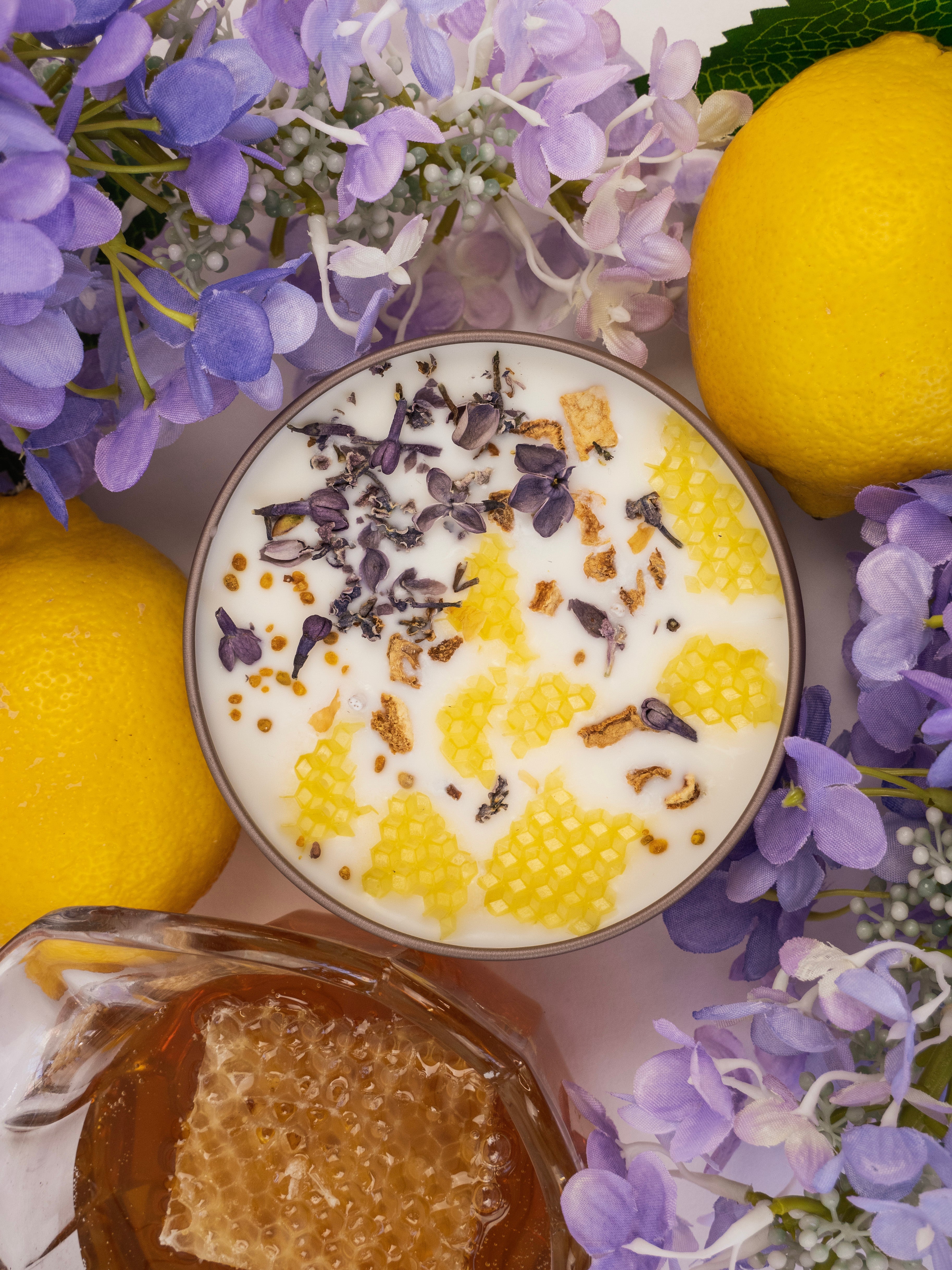 Yogurt with honeycomb, lavender flowers, and lemons on a white background