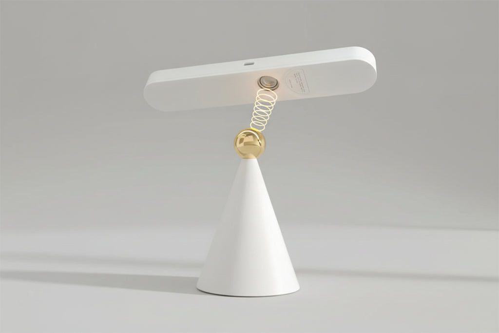 Modern table lamp with white base and gold accent on a beige background