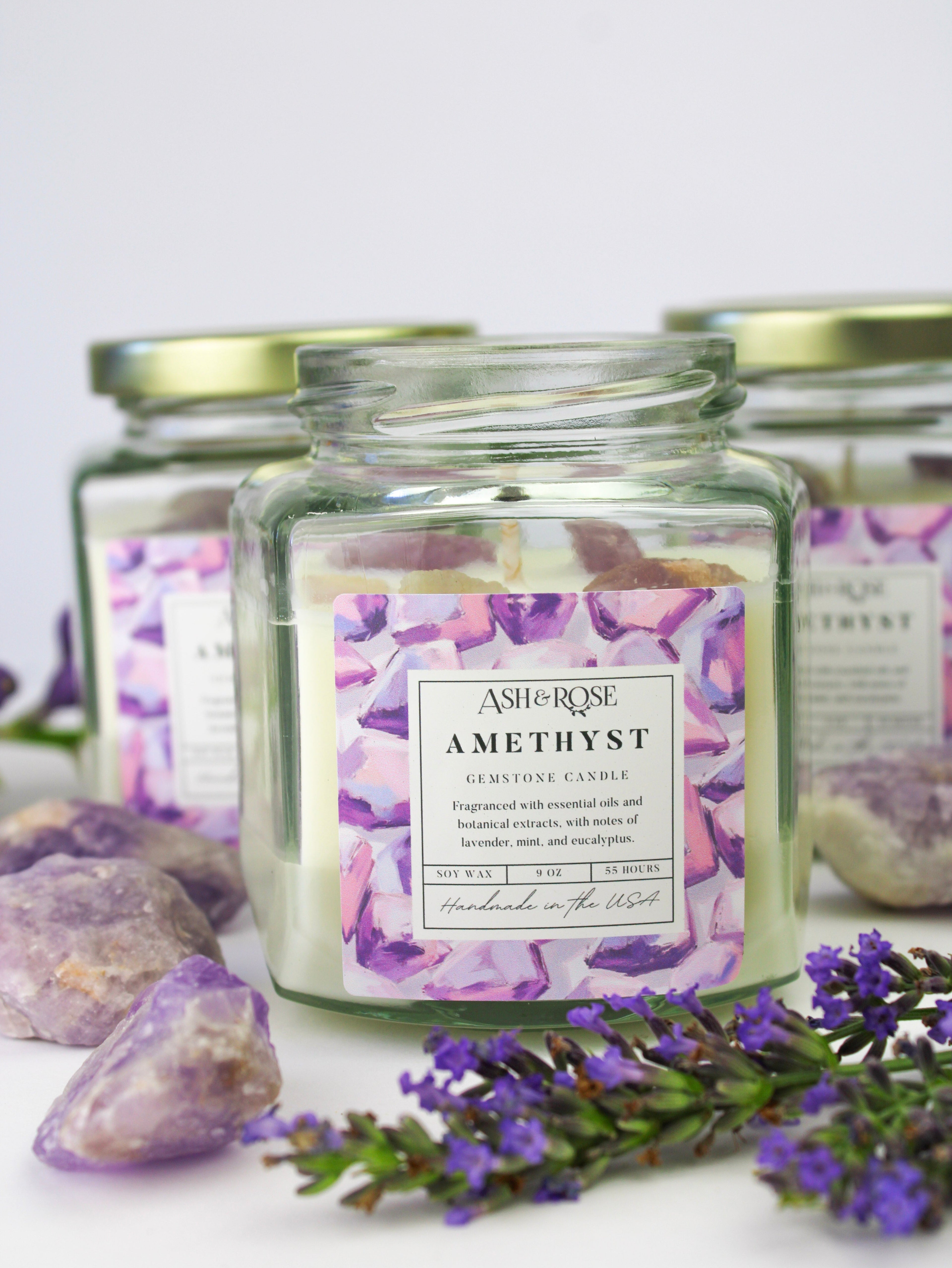 Jar of Ash & Rose Amethyst candle with lavender flowers and crystals on a white background
