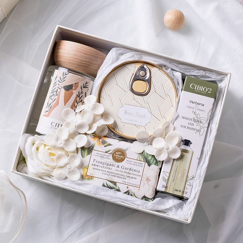 Gift set with decorative items and a small plant on a light background