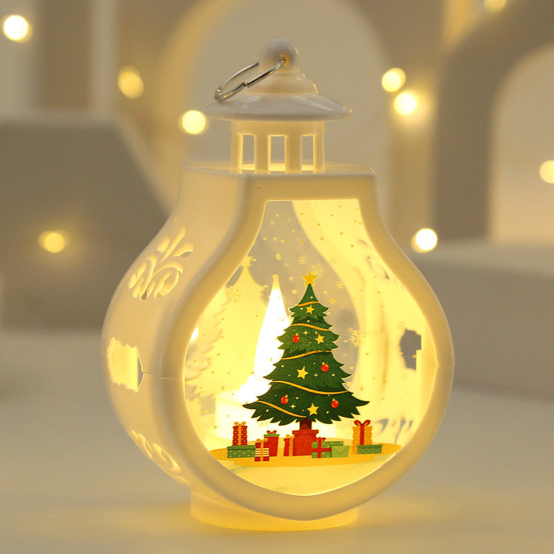 Decorative lantern with a Christmas tree and presents inside, glowing softly.