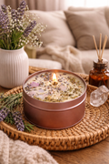 Handmade lavender soy candle with dried herbs and crystals, styled on a woven tray in a cozy living room decor setting.