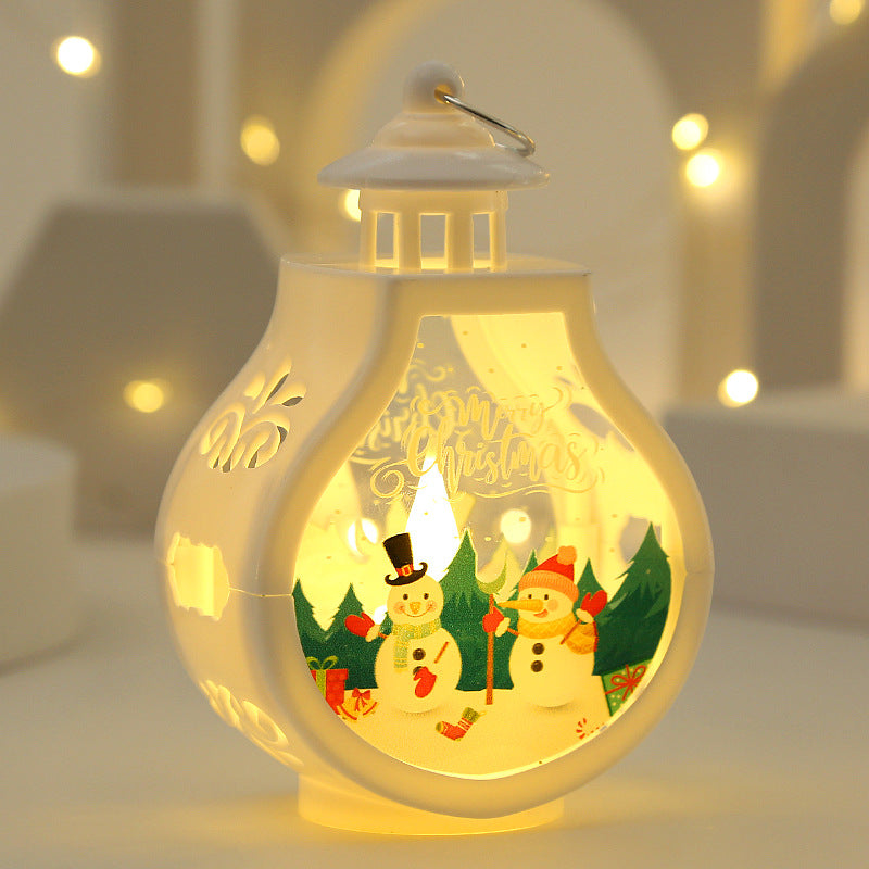Decorative lantern with a Christmas scene inside, glowing warmly against a blurred background.